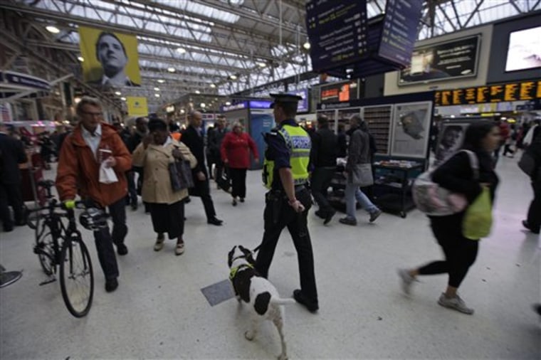 A police officer with a dog, patrols a central London train station, Monday Oct. 4, 2010. Britain's Foreign Office has upgraded its travel advice for France and Germany, warning Britons going to those countries that the threat of terrorism there is high. Britain's Home Secretary Theresa May said that the threat of terrorism in the U.K. remains unchanged at "severe," meaning an attack is highly likely. 